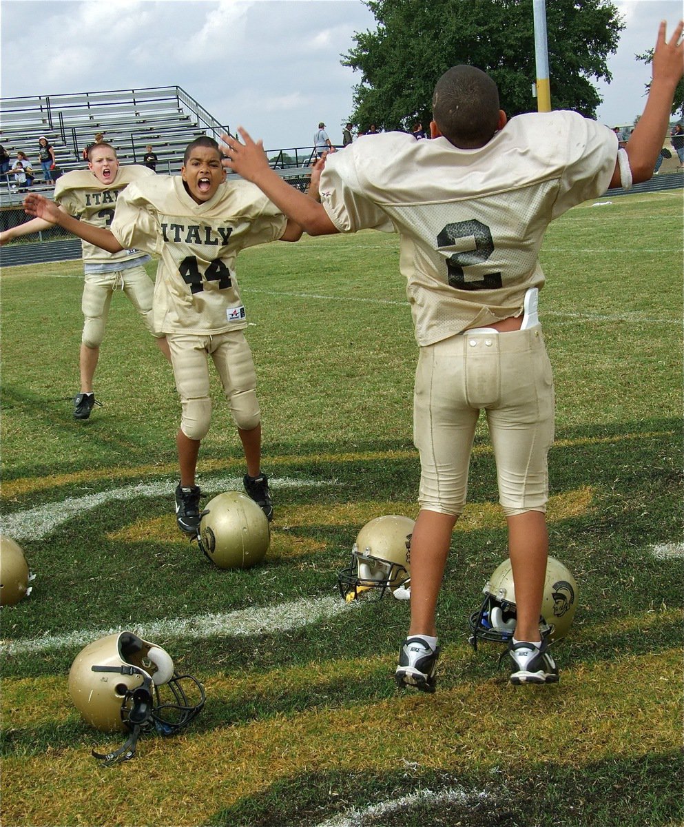 Image: Jumping for joy — Tylan Wallace(2), Keelan Azakytu(44) and Clay Riddle(31) celebrate their win in Hubbard.