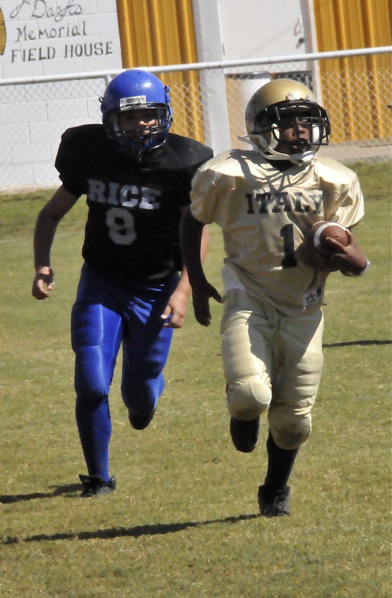 Image: Nice, doggy! — IYAA A-Team Gladiator Kendrick Norwood(1) is being chased by a Bulldog down the Italy sideline.