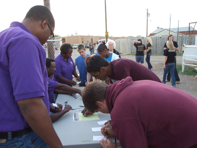 Image: Pastor Mitte Muse oversees — Mt. Zion Church from Italy helps the students check in and get a name tag.