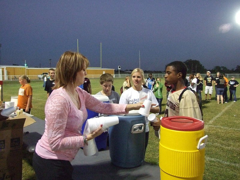 Image: Janet Campbell offers refreshment — First Baptist Church of Italy member, Janet Campbell, gets cups ready for the long line of lemonade recipients.