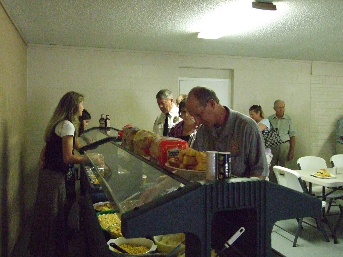 Image: “Thank you for this food” — A wonderful meal was provided to the firemen and their families.  Fried chicken and brisket. Yummy!