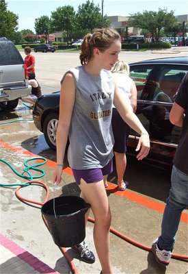 Image: Bucket-o-fun — Melissa Smithey keeps the water flowing to the car washers.