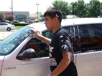 Image: All clean now — Reid Jacinto will be able to skip his Saturday night bath after participating in the IHS Band car wash.