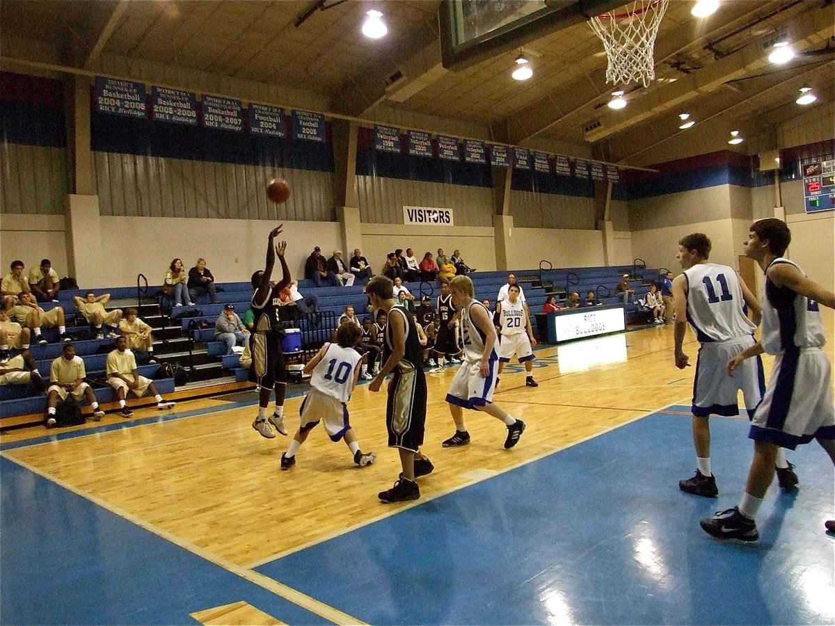 Image: A  J.V. Gladiator hits a jumper from the wing over a Bulldog defender.