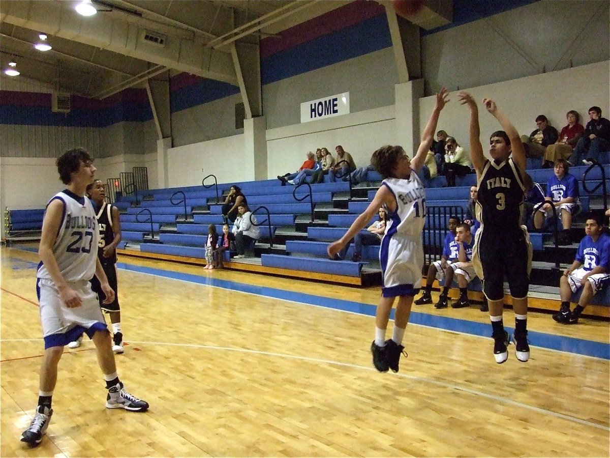 Image: 3 takes a three — Reid Jacinto(3) tries to drop in a 3-pointer over a Bulldog defender.