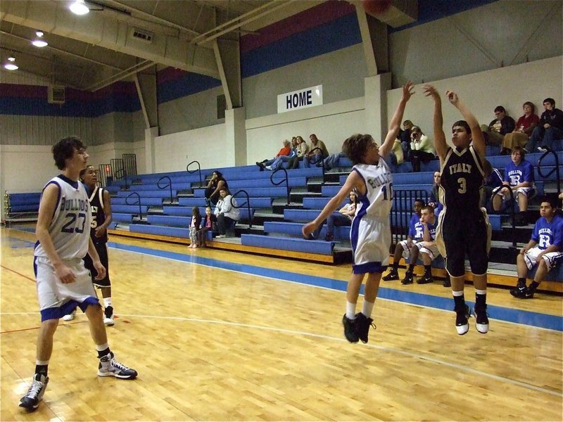 Image: 3 takes a three — Reid Jacinto(3) tries to drop in a 3-pointer over a Bulldog defender.