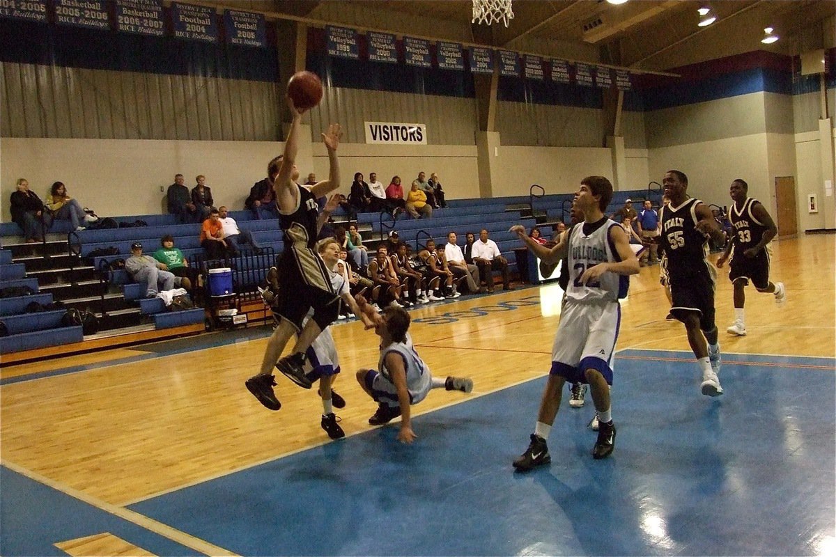 Image: Haden hounded — Haden Woods(1) scores a fast break layup with Bulldogs nipping at his heels.