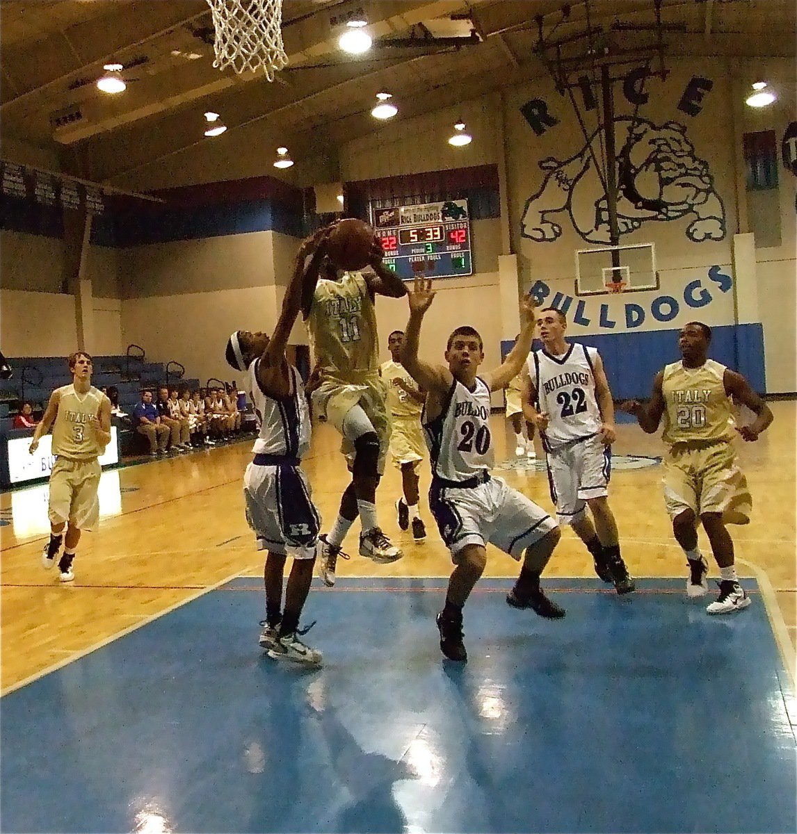 Image: Excuse me! — Jasenio Anderson(11) splits two Bulldog defenders on his way to the hoop and an 18-point night.