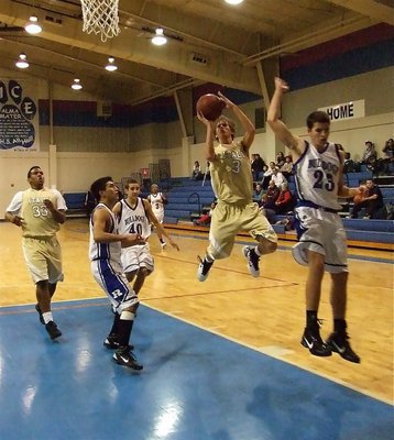Image: High flyer — Jase Holden(3) does whatever it takes to score the basket.
