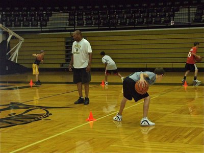 Image: Mayberry monitors — Coach Larry Mayberry oversees cone drills during the camp as John Escamilla, Tylan Wallace, Ty Windham and Scott Connor complete the drill.