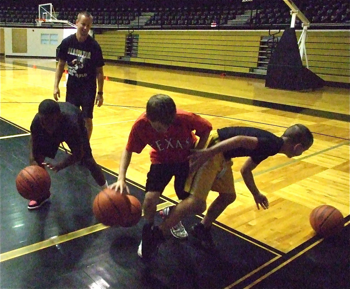 Image: Sharking — Campers try to keep their dribble alive while deflecting each others basketball until just one dribbler remained.