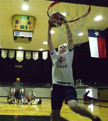 Image: Clay jams it home — Clay Riddle rises for a slam during the camp.