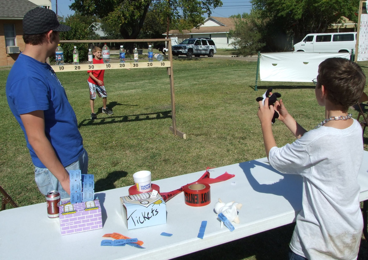 Image: Beanie Bag Toss — Throw a bag and knock the bottle off to receive the amount of tickets indicated.