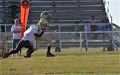 Image: Preston gets the first — Preston Rasco(13) drags a Dawson Bulldog player past the first down marker which is being held by Cody Boyd who plays for the Italy Junior High team.