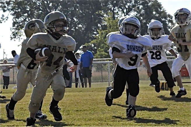 Image: Bryce rumbles — Bryce DeBorde(44) breaks into the open field during the Bantam game. DeBorde later added a touchdown in the contest.