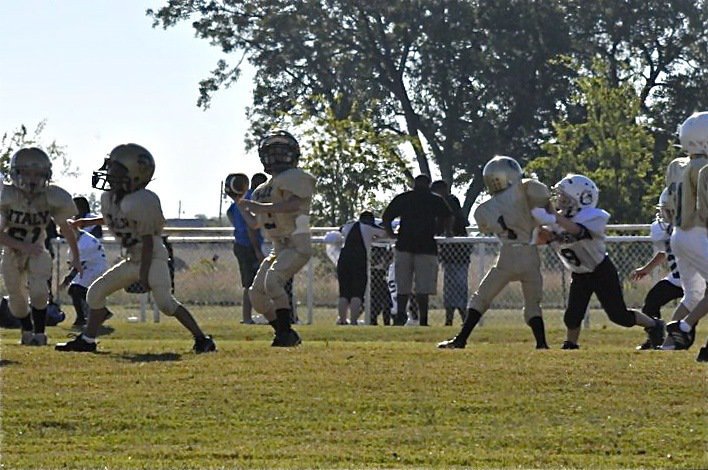 Image: Rasco in the pocket — Ty Cash(61), Jalyn Wallace(2), Taylor Sparks(1) and Brennon Boyd(31) create a passing pocket for quarterback Preston Rasco(13) who fires a bullet pass to Laveraneus Green. Rasco completed two passes to Green with one good for a touchdown.