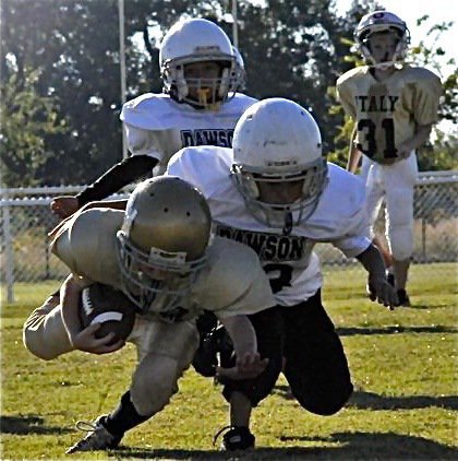 Image: Ty tackled — Ty Cash gets tackled after gaining yards against the Bulldog defense during the Bantam game.