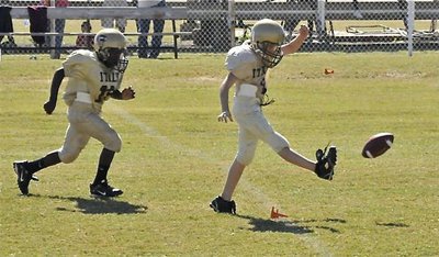 Image: Slick kick — Ryder Itson(10) kicks off to Dawson to start the Minors (3rd &amp; 4th) game while teammate Taron Smith(10) tracks the ball.