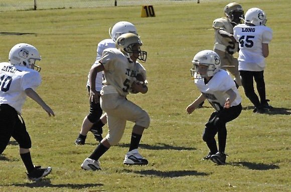 Image: Lineman’s dream — With the game well in hand, head coach Gary Wood inserts an offensive lineman, Donald Hayes, into the backfield to show he can run with the dogs.