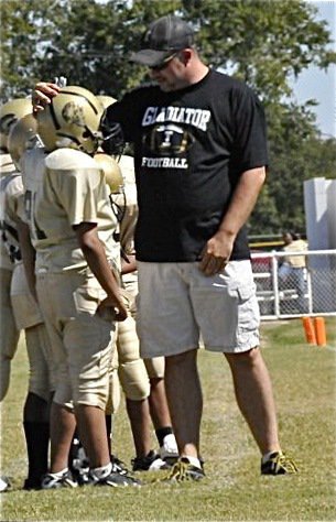 Image: Mark offers congrats — Majors coach Mark Souder offers congratulations to one of his lineman.