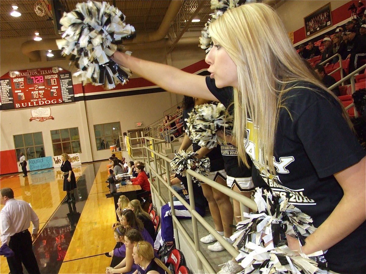 Image: Lexie’s into the game — Italy High School cheerleader Lexie Miller tries to urge the Lady Gladiators back into the game after Italy fell behind 10-2.