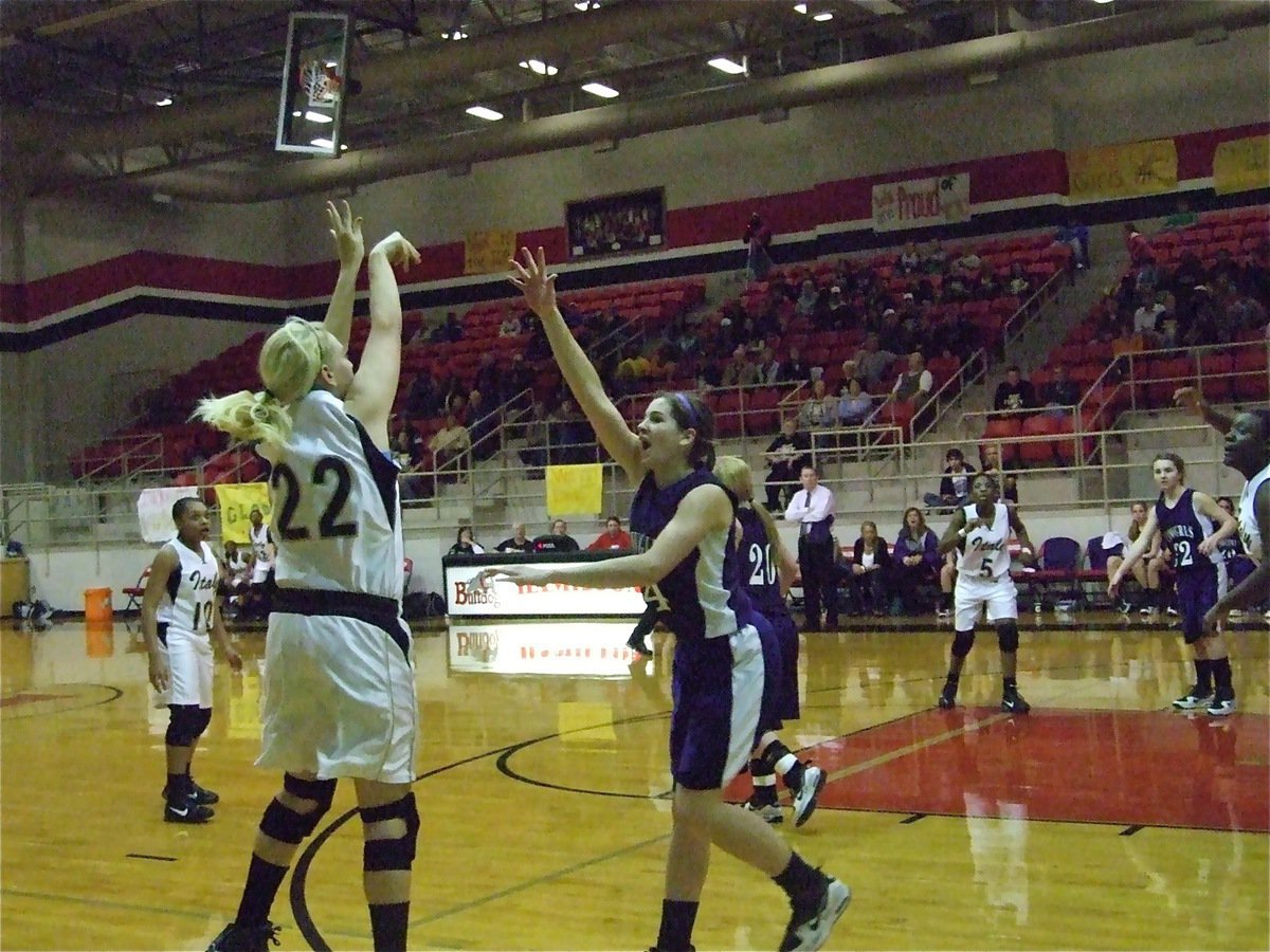 Image: Megan shoots — Megan Richards(22) shoots a 3-pointer over a Mason defender.