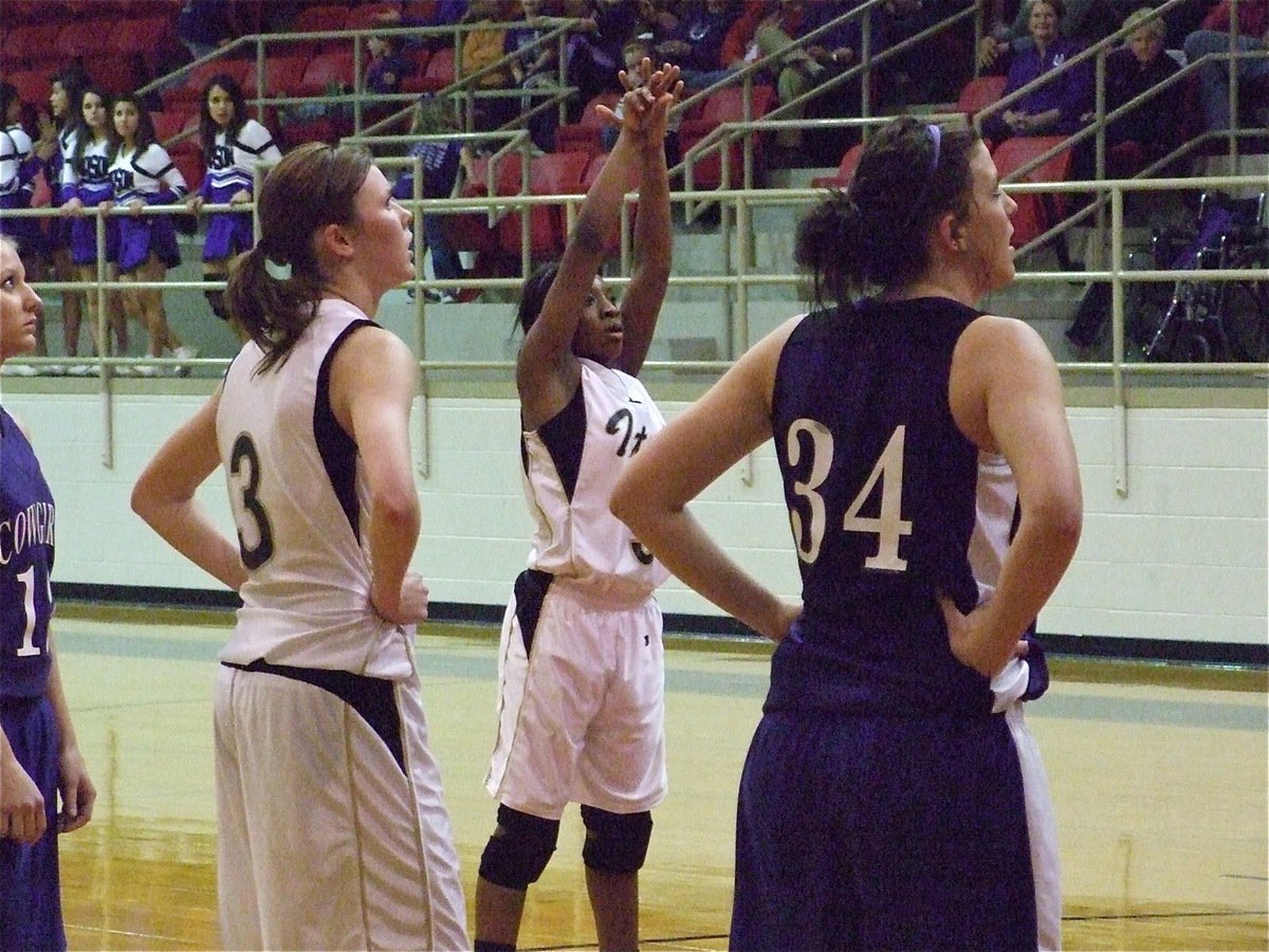 Image: Jameka Copeland — Jameka Copeland(5) takes a free shot in the area championship against Mason as teammate Kaitlyn Rossa(3) watches it fall.