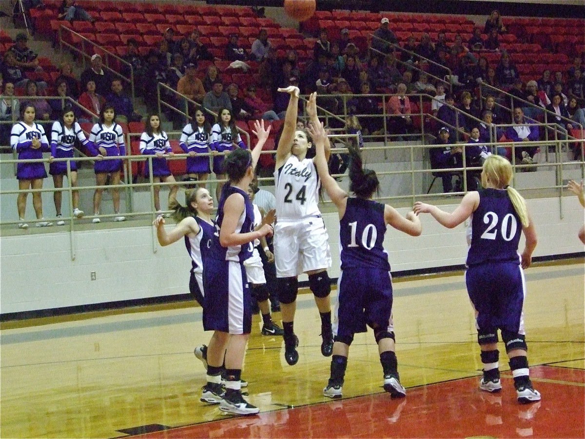 Image: Alyssa rises — Lady Gladiator Alyssa Richards(24) shows her freshman form in the area championship game in Hamilton.