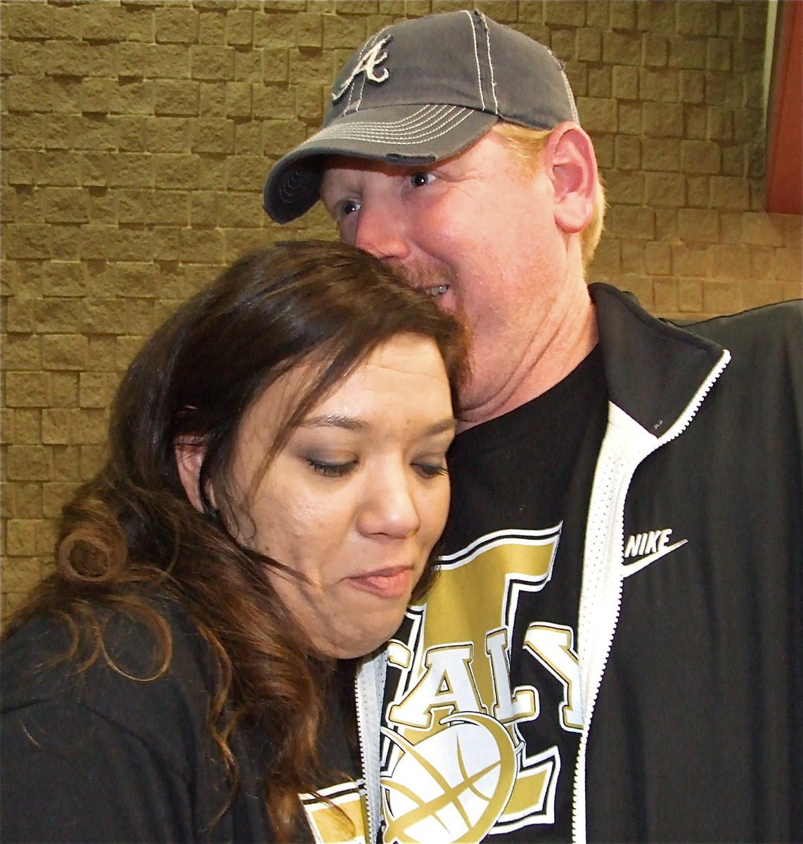 Image: I love you! — Lady Gladiator assistant coach Tina Richards gets a hug from her husband Allen Richards after the loss to Mason.