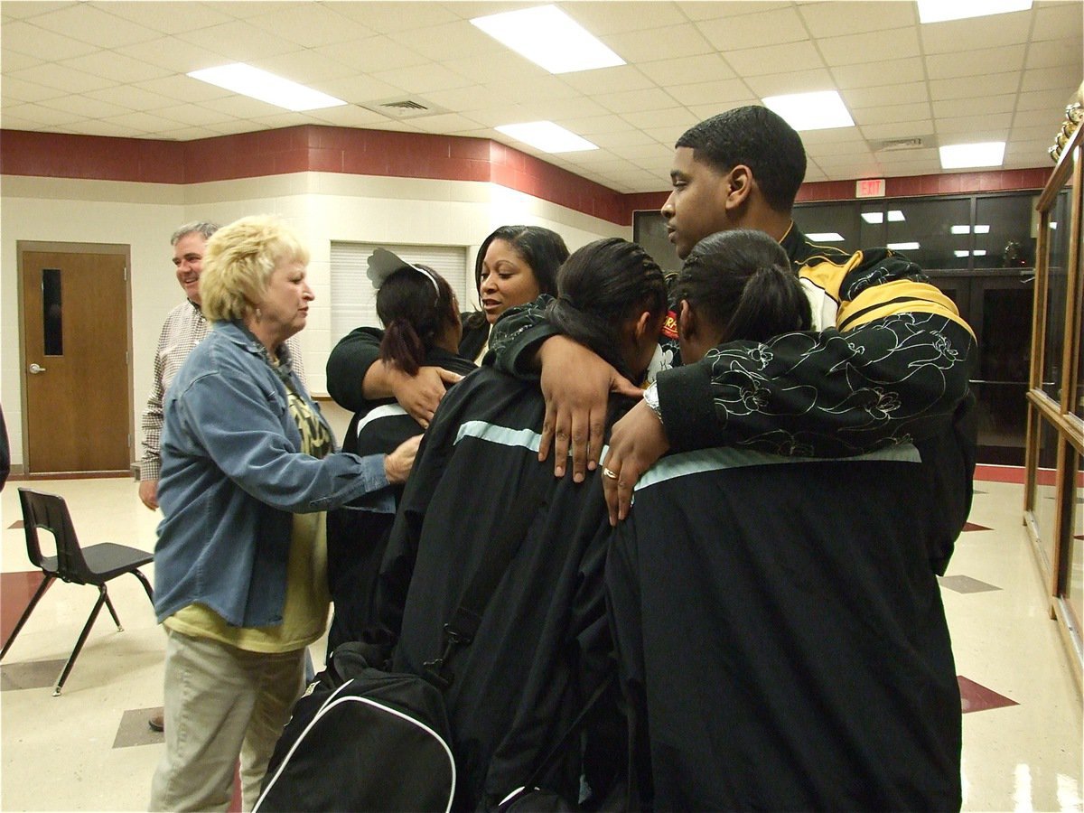 Image: We’ll be back — Jameka Copeland, Kyonne Birdsong and Chante Birdsong get comforted after the game.