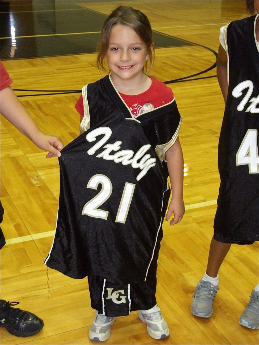 Image: I’ll fill this out — Evie Hernandez gets a little help from fellow campers while displaying her jersey numbers.