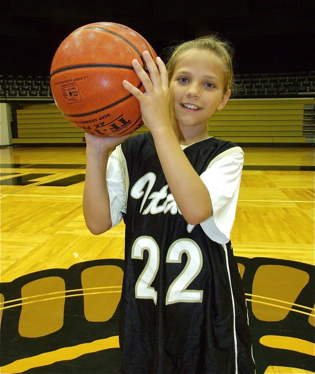 Image: Paige goes by the book — Paige Henderson shows her shooting form she practiced during the four day camp.