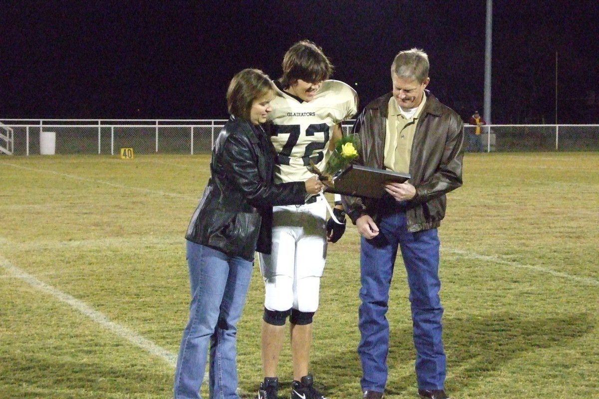 Image: Tyler Boyd — Tyler Boyd and his parents enjoy the photo collage he was given.