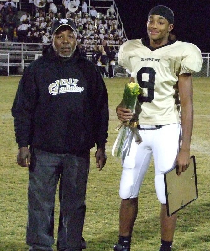 Image: Dontavious Clemons — Mr. Green escorts Dontavious Friday night.