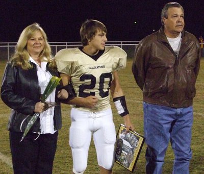 Image: Clay Major — Clay is escorted by his mom and dad.