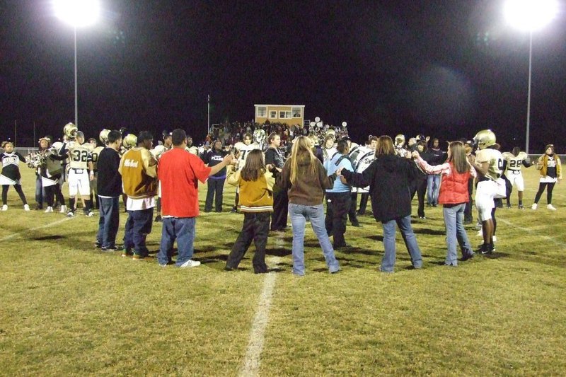 Image: Last Song At Willis Field — The seniors gather together to sing the school song after the game.