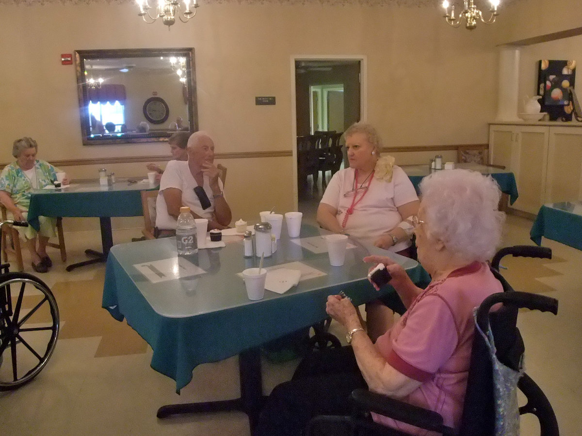 Image: Cupcakes and Conversation — These folks are having fun celebrating birthdays.