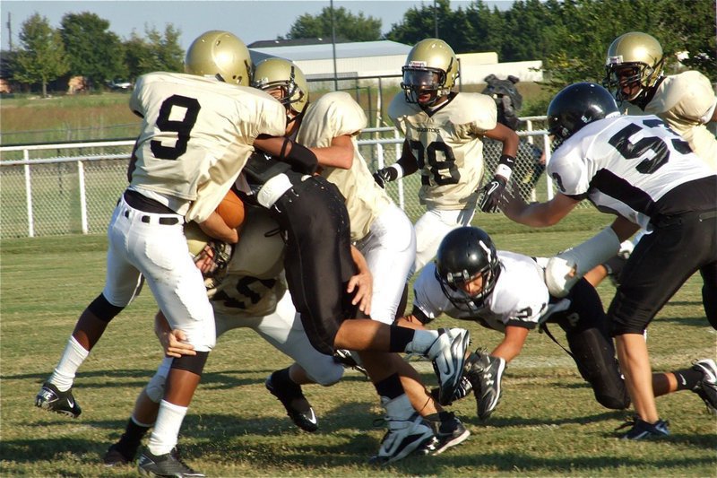 Image: Italy’s JV Gladiators try to get a handle on the Bulldogs — Italy JV Gladiators Trevon Robertson(9), Chase Hamilton(10), Zackery Boykin(55) and Eric Carson(28) had their hands full against the Palmer Bulldogs during their bye week.