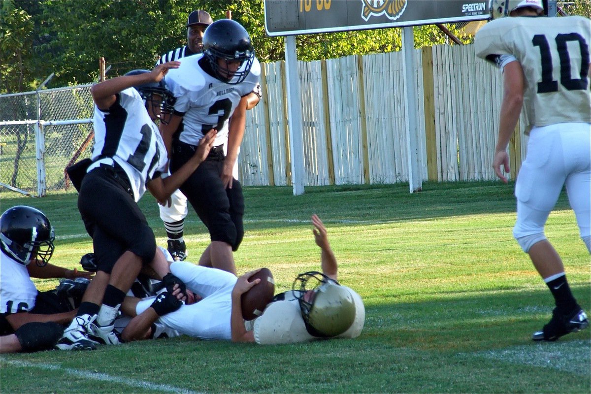 Image: Wood backs across — Justin Wood fights his way thru the Bulldog defense and then falls into the endzone.