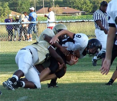 Image: We got him! — Italy’s Adrian Reed (64) and Paul Harris bring down a Palmer runner.