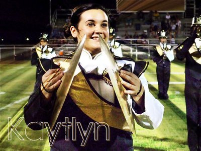 Image: Kaytlyn Bales — Gladiator Regiment Band member Kaytlyn Bales radiates gold while smashing the cymbals together.