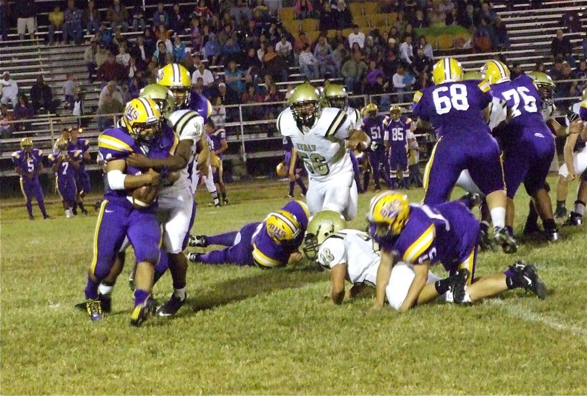 Image: Jamal makes tackle — Italy’s noseguard Jalarnce Jamal Jewis(30) wraps up Aurelio Dominguez(34) before the Bison runner can cause any more damage.