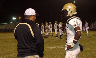 Image: Game planning — Gladiator head coach Craig Bales and quarterback Jasenio Anderson(11) try to formulate a plan.