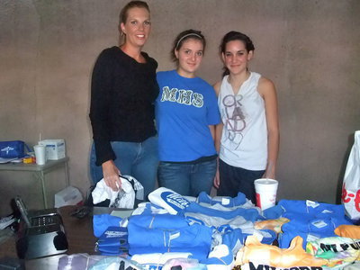 Image: Cheerleaders Booth — Jennifer Hagen, Melissa Swift and Rachel Strange selling shirts and hosting a cake walk to raise money for the Milford ISD cheerleaders.