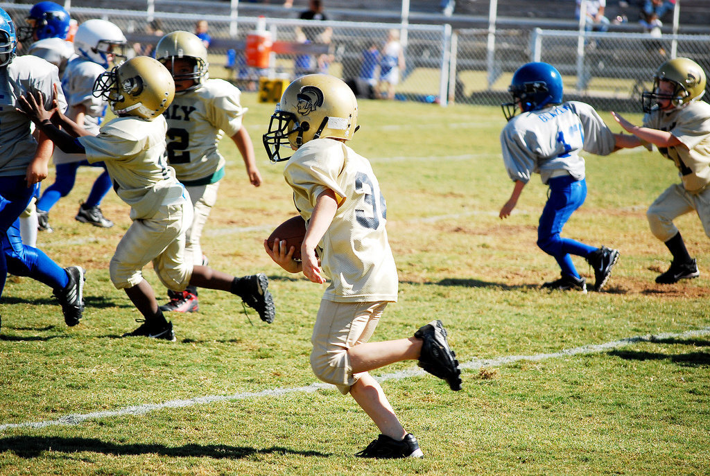 Image: Clear for takeoff — Ricky Pendleton, Nicolas Gomez and Levi Stark clear the way for running back Corbin Schrotke.