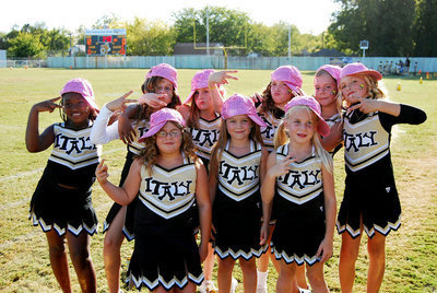 Image: B-team cheerleaders — The girls strike a pose after their halftime performance.