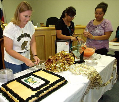 Image: Becky cuts cake — Becky Boyd does the honor of cutting the cake for all to enjoy as the punch gets served.