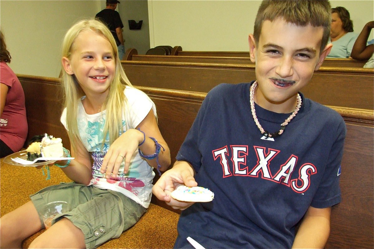 Image: Got milk? — Lacy Mott laughs at the cake colored lips of her bother, Trevor Mott.