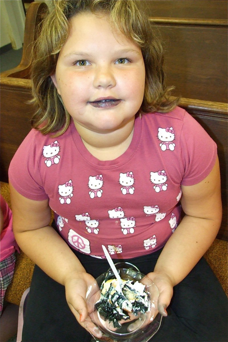 Image: Cake smacking good — IYAA Cheerleader Virginia Stephens realizes cake could make good Halloween makeup.