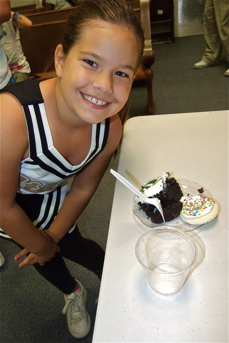 Image: Nevaeh Salcido — IYAA Cheerleader Nevaeh Salcedo enjoys the treats while adorning her cheerleading outfit.